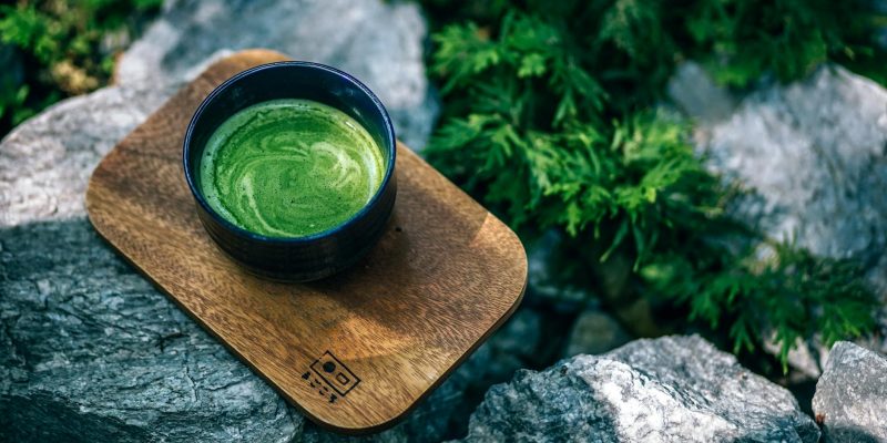 photo of matcha drink on a wooden tray
